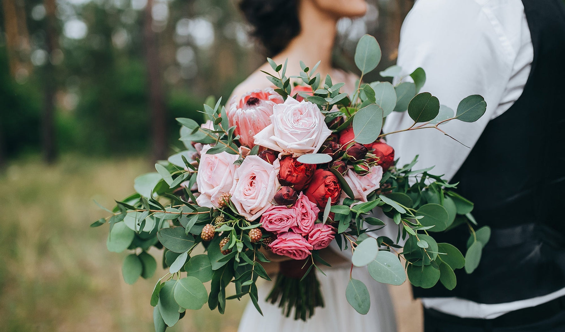 DIY faux bridal bouquet featuring pink and red roses from Silks Are Forever