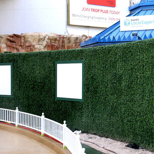 A boxwood-covered wall beside a curved outdoor walkway in Las Vegas, photographed in 2011
